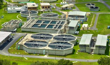 Aerial view of modern water cleaning facility at urban wastewater treatment plant. Purification process of removing undesirable chemicals, suspended solids and gases from contaminated liquid.