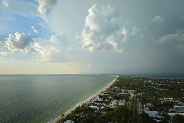 Aerial view of tropical storm over rich neighborhood with expensive vacation homes in Boca Grande, small town on Gasparilla Island in southwest Florida.