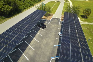 Solar panels installed over parking lot for parked cars for effective generation of clean energy.