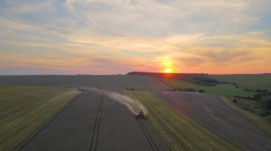 Buğday tarlasında hasat mevsiminde çalışan hasat makinesinin hava görüntüsü. Tarım kavramı.