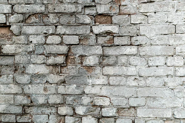 Parede de tijolo texturizado velho cinza com rachaduras para fundo — Fotografia de Stock