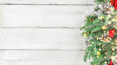 Fluffy Spruce noel şubesi yan görüntüde, beyaz, ahşap arka planda ışıklar ve kopyalama alanı var. Noel arkaplanı, kartpostal ya da hediye paketi için fotoğraf.