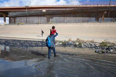 12-30-2021 Haitian man carries his daughter on his shoulders to cross the Rio Grande natural border between Mexico and the United States to request humanitarian asylum migration, clipart