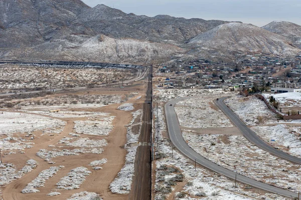 Snowy landscape of the wall that divides Mexico from the United States on the border between Ciudad Jurez and Paso Texas,