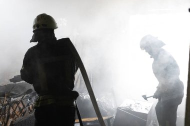 04-17-2022 firefighters work in a burning building after a Russian missile fell on the housing unit.