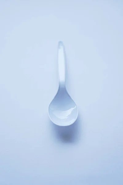 White disposable plastic spoon used for eating isolated on white