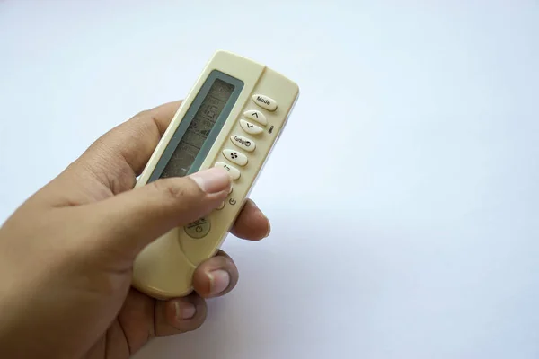 human hand on used remote air conditioner until it turns yellow isolated on white