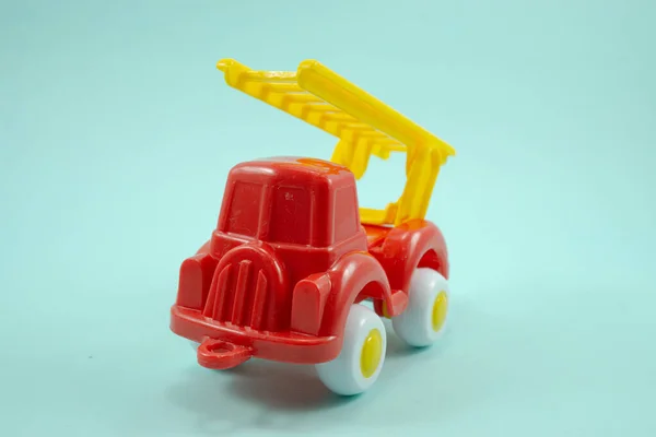 Red Paint Plastic Toy Fire Truck Yellow Ladder Isolated Turquoise — Stock Photo, Image