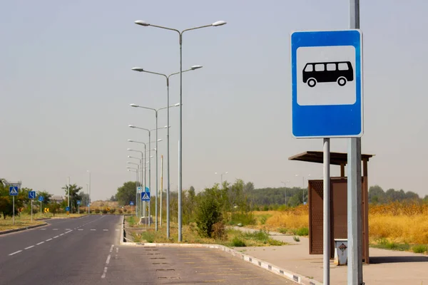 Otobüs durağının yanındaki mavi arkaplanda dur tabelası var.