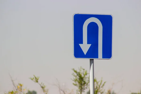 traffic direction sign white reverse arrow on blue background