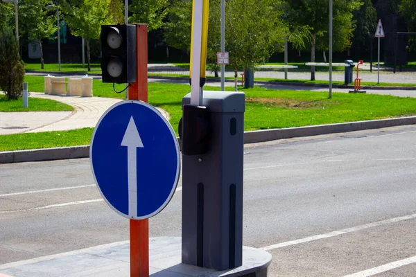 traffic direction sign at the barrier white arrow on blue background