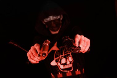 man with guns on a black background, gangster