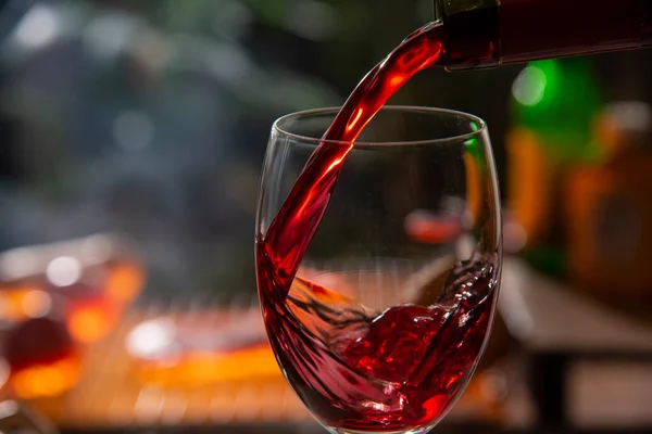 Red Wine Pouring Glass Bar Cue Grill Bokeh Background — Foto Stock