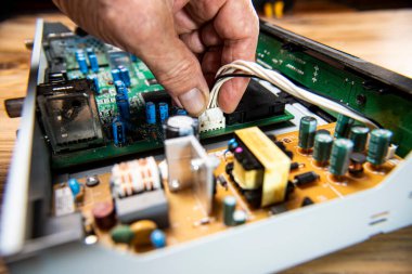 man hand fixing electronic circuit