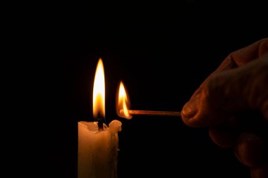 man hand lit candle