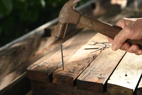 Person Pounding Nail Hammer Wood Plank — 스톡 사진
