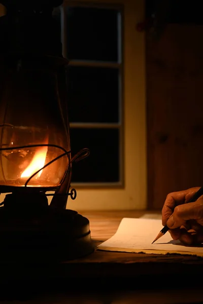 Man Hand Writing Kerosene Lamp Light — 图库照片