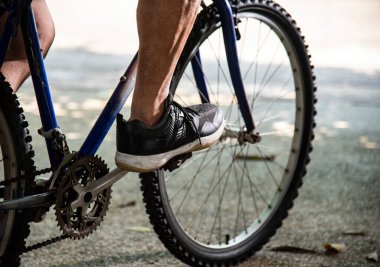 close up of person riding bicycle outdoors