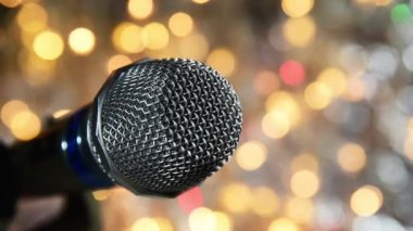 Renkli flaşlı arka planda gümüş metalik mikrofon