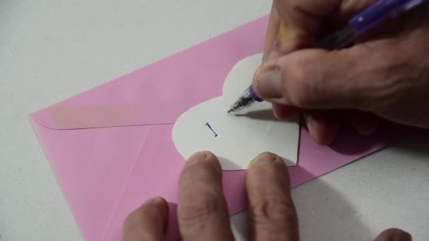 Man Hand Writing Letters Heat Shape Paper — стоковое видео