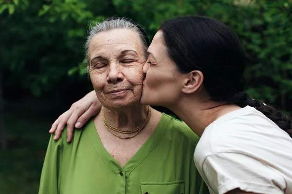 Granddaughter Kissing Her Grandmother Garden Stock Image