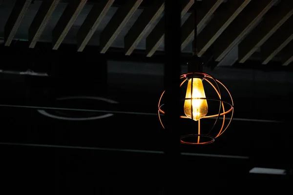 lightbulb in a dark room, view from below