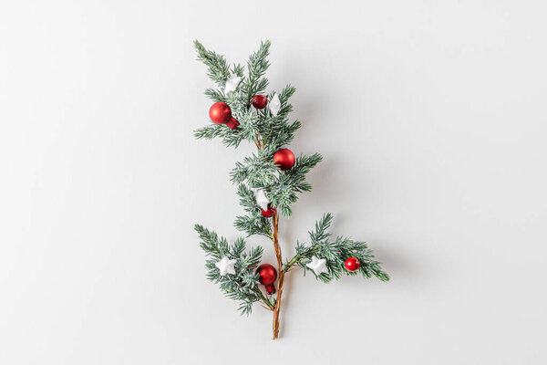 Christmas Background. Fir tree branch with decorations on white background. Flat lay. Minimal concept. Top view