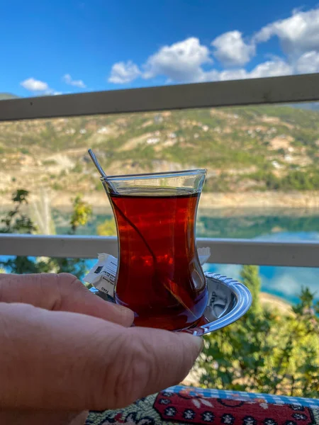 Turkish glass with tea in hand