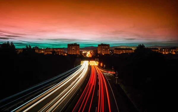 Rays of lights, in slow motion, of cars driving on the highway at night to enter and leave the city of Granollers, Barcelona.