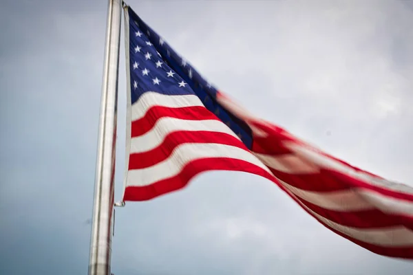 The American Flag waves in the breeze in front of an overcast late afternoon sky in Washington, D.C. in July 2022