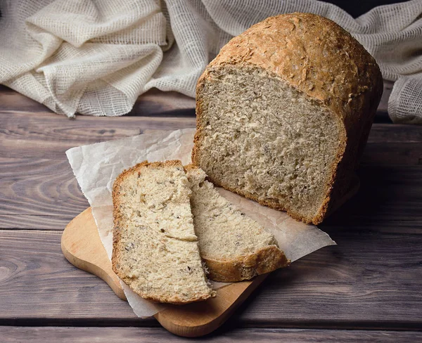Fresh homemade Whole grain wheat bread. Bread texture. Traditional sourdough bread cut into slices on a rustic wooden background. Concept of traditional leavened bread baking methods. Selective focus.