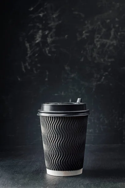 Paper coffee cup with cap mockup on dark background. take away coffee cup mockup,  paper coffee cup. To go coffee cup  for web design. Take coffee with you.  Street morning coffee.