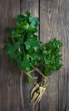 Fresh celery, parsley, basil and dill on a wooden background.health. Fresh green organic celery. Fresh leaf celery. BIO vegetables.Herbs and spices. Aromatic ingredients.Vegetarian rustic food concept