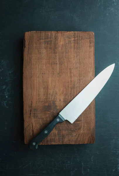 Cutting board and knife, baskets for food. Harvest. Menu. Recipe. Food blank background.Empty table. Country kitchen.  Kitchen utensils. Knife on an empty kitchen board, Empty place. Top view.