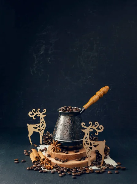 The concept of coffee drinks. Winter holidays concept with favorite coffee. Coffee beans and handmade wooden figurines with a winter themed. Winter coziness. Christmas is coming.