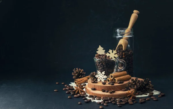 The concept of coffee drinks. Winter holidays concept with favorite coffee. Coffee beans and handmade wooden figurines with a winter themed. Winter coziness. Christmas is coming.