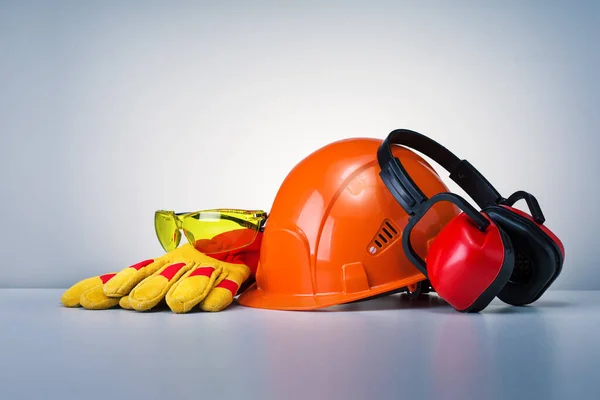 Personal Protective Equipment On Grey Background. Work Safety Concept.