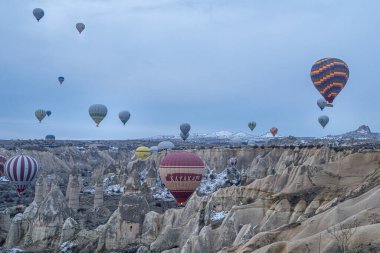 Türkiye 'nin başkenti Kapadokya' daki dağ manzarası üzerinde uçan sıcak hava balonlarının (atmosfer balonları) sabah başlangıcı