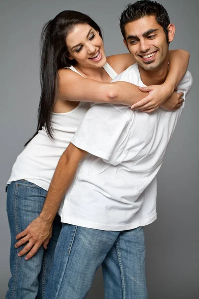 Young Casual Happy Couple Playing Stock Image