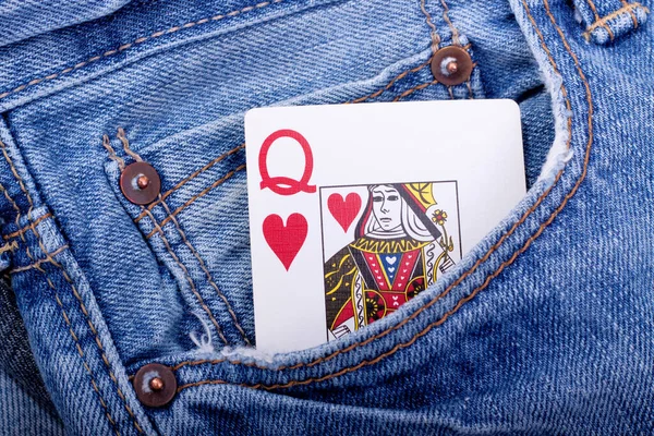 Queen of hearts playing card in blue jeans pocket
