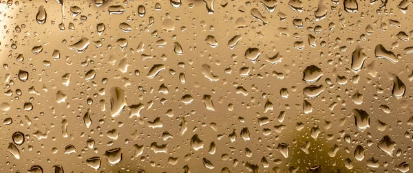 Abstract Water Drops Glass Yellow Background — Zdjęcie stockowe