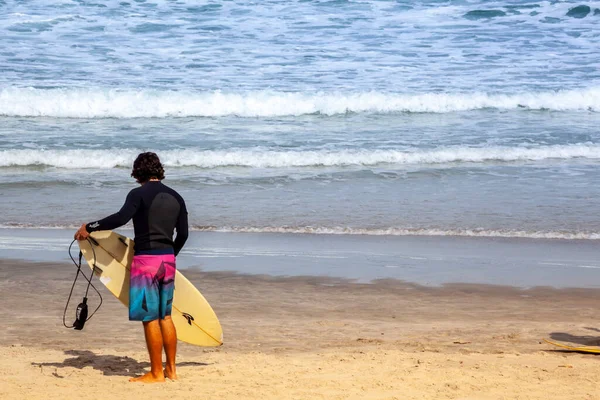 Sao Sebastiao, Sao Paulo, Brazil, May 17, 2015. Surfer with his board prepares his entry into the sea at Cambury beach in Sao Sebastiao, north coast of the State of Sao Paulo.