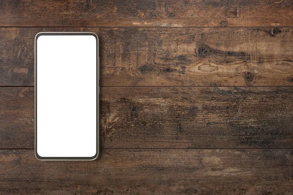 Ahşap masada sahte cep telefonu. Akıllı telefonlu ahşap batı kırsal masası. Kahverengi tahta arka planda fotokopi alanı olan boş ekran cep telefonu. Cep telefonu ahşap masada.