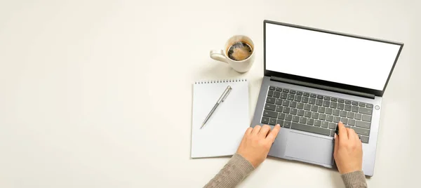 Laptop with blank screen, hands and accessories on white. Home office workspace mockup. Laptop with blank screen, hands and accessories on white. top view. wide banner