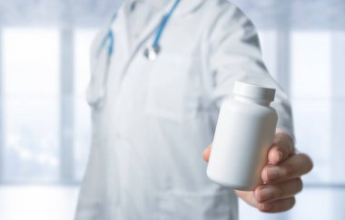 Doctor recommends medicine pill. Practitioner with bottle of pills. hand hold white plastic pill bottle. doctor giving pill jar to patient. physician holds out his hand with jar of pills