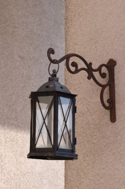 old vintage lantern on a background of a wall