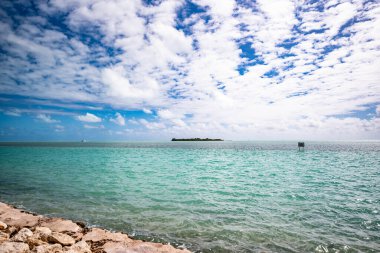 Florida Keys 'ten okyanus manzarası. Su bir Türk rengidir ve gökyüzü mavi bulutlar görünür. Bu fotoğraf çekildiğinde hava sıcaktı. Rüzgar suda dalgalar yaratır..