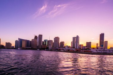Miami, Florida şehir merkezi, gün batımında gökyüzü Maimi Güney Kanalı 'nın sularındaki bir tekneden alındı.