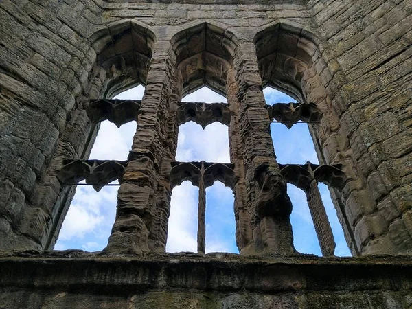 A view through the windows of the great call of the ruins of Hawksworth Castle in northern England