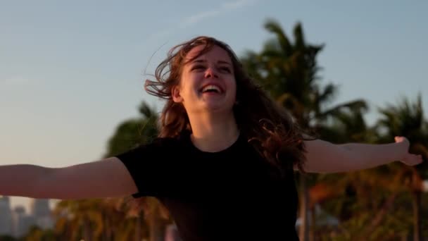 Mujer feliz disfruta de la maravillosa puesta de sol en la playa de Miami — Vídeos de Stock